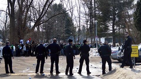 Police officers, one of whom is pictured here armed with pepper spray gun, prepare to clear an area of Brandywine during Blarney Blowout on Saturday, March 8. (Conor Snell/Daily Collegian)