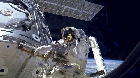 Astronaut James H. Newman waves during a spacewalk preparing for release of the first combined elements of the International Space Station. The Russian-built Zarya module, with its solar array panel visible here, was launched into orbit fifteen years ago on Nov. 20, 1998. Two weeks later, on Dec. 4, 1998, NASAs space shuttle Endeavour launched Unity, the first U.S. piece of the complex. During three spacewalks on the STS-88 mission, the two space modules built on opposite sides of the planet were joined together in space, making the space station truly international. (NASA/MCT)