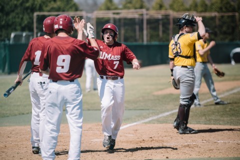 Rob McLam high fives teammates after scoring another run. (Judith Gibson-Okunieff/Daily Collegian)