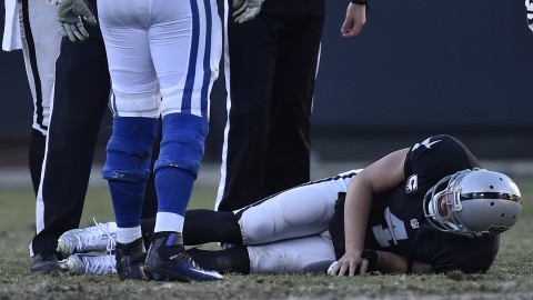 Oakland Raiders quarterback Derek Carr (4) sustains an injury after being tackled by the Indianapolis Colts' Trent Cole in the fourth quarter at the Coliseum in Oakland, Calif., on Saturday, Dec. 24, 2016. (Jose Carlos Fajardo/Bay Area News Group/TNS)