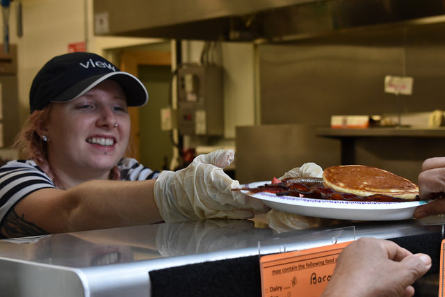 Victoria Desclos, center, serves food at Amherst Survival Center, Amherst MA, Sept. 29, 2018.