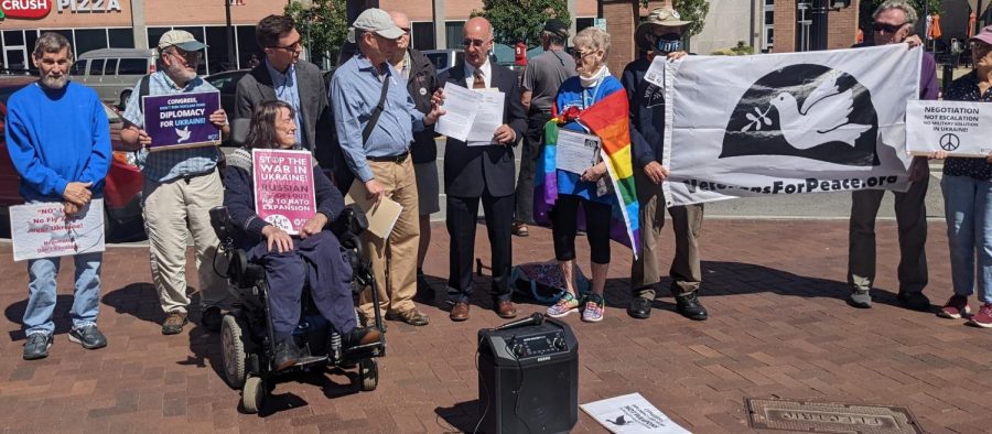Representative Stephen Lynchs staffer, Nick Zaferakis, accepting a letter and petition from Mass Peace Action Executive Director Cole Harrison. Other demonstrators are also pictured.
Peter Blandino/Daily Collegian.