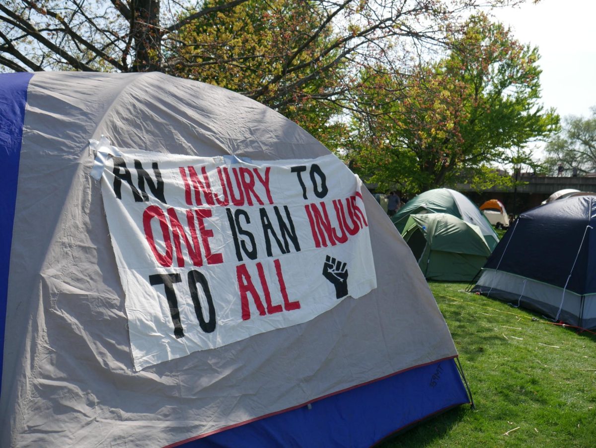 An+injury+to+one+of+an+injury+to+all+read+a+sign+attached+to+a+tent.+Many+tents+were+adorned+with+signs+showing+solidarity+with+Palestine+or+calling+for+divestment.+